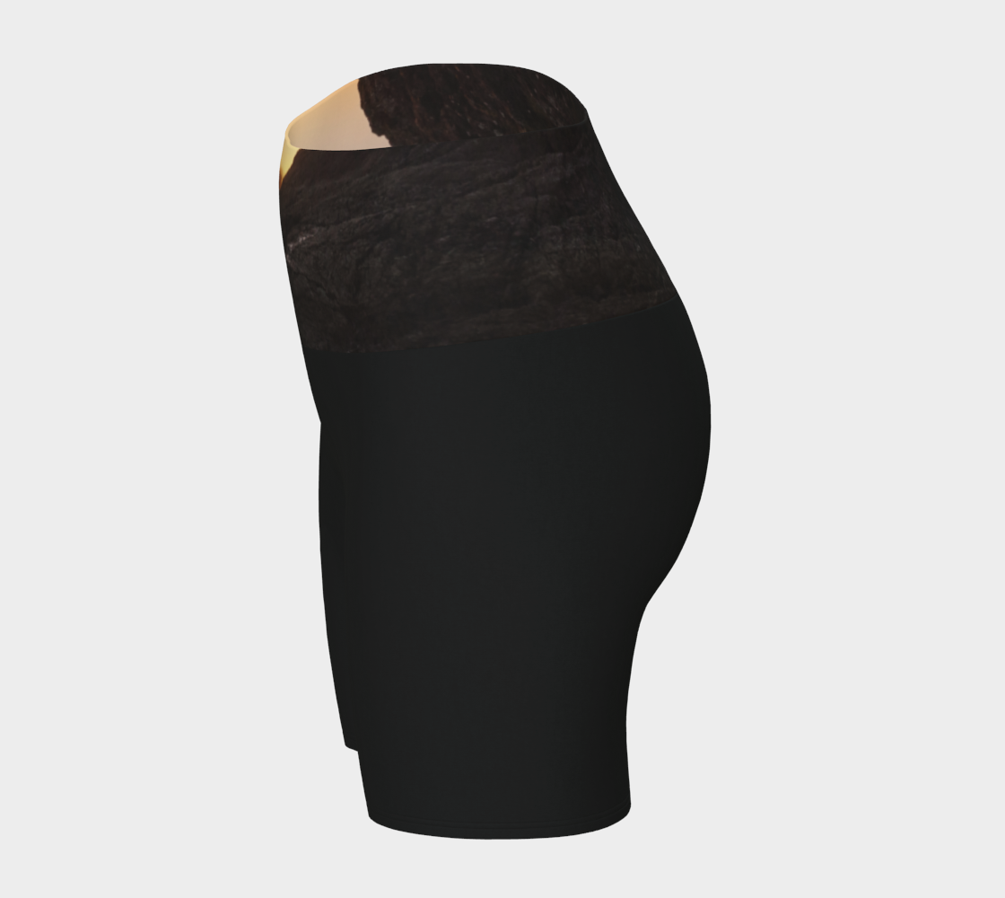 Tofino Sunset Yoga Shorts features an image of a sunset at long beach tofino printed on the waistband. the rest of the shorts are black.