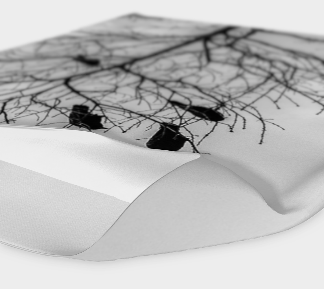 headband neck gaiter with a image of a tree with several crows in it. Black and white.
