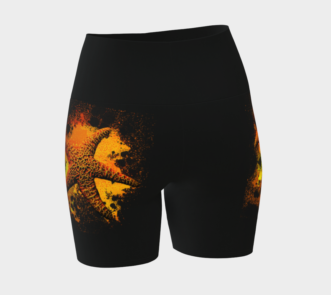 Starfish Orange Yoga Shorts features a orange starfish on a bed of abstract sand on black shorts.