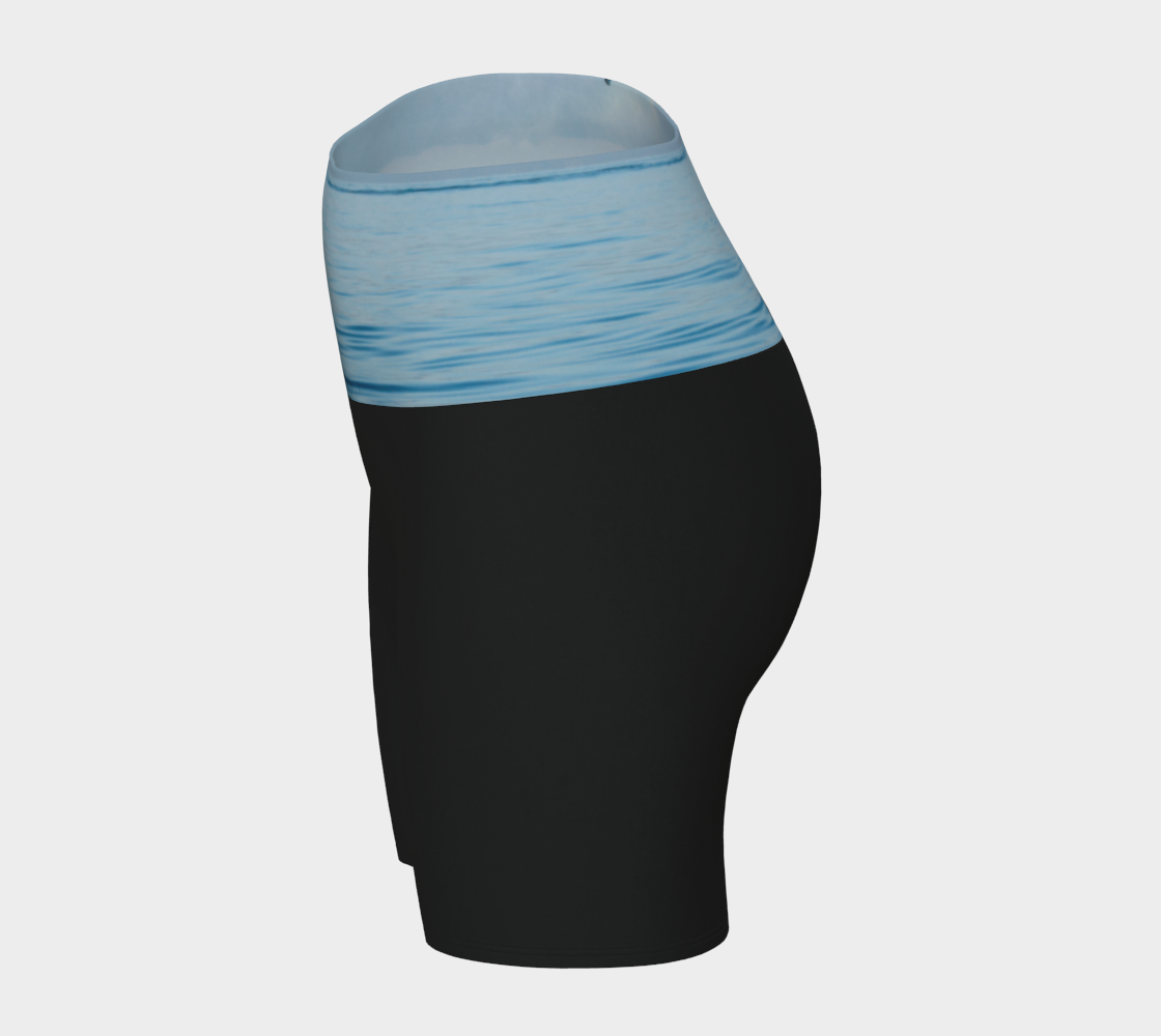 Orca Spray yoga shorts features a image of an orca exhaling on the ocean. This image is printed on the waistband and the rest of the shorts is black.