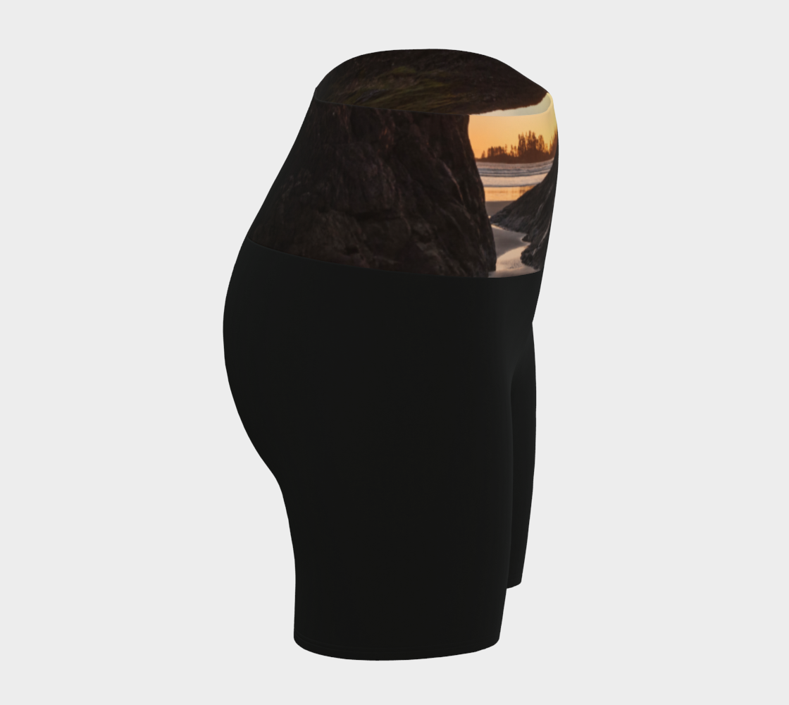 Tofino Sunset Yoga Shorts features an image of a sunset at long beach tofino printed on the waistband. the rest of the shorts are black.