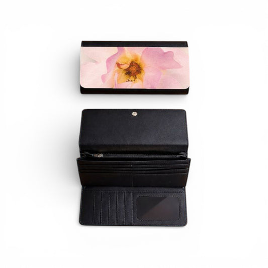 Black wallet with floral design on flap on a white background