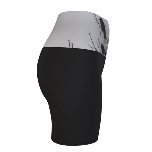 Right side Crows Yoga Shorts feature a photograph of crows sitting in a tree printed on the band of the yoga shorts. The bottom of the yoga shorts are black.