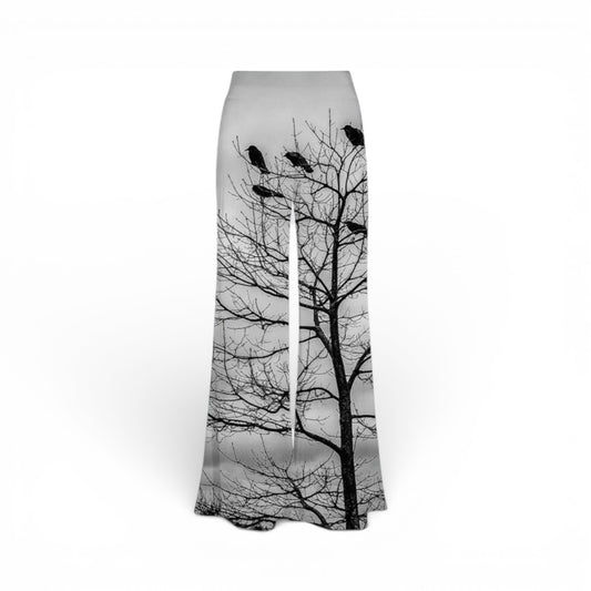Flared pants with a tree and bird design on a white background