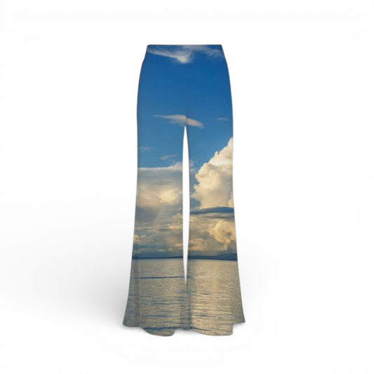Pants with a scenic print of a sunset over water on a white background