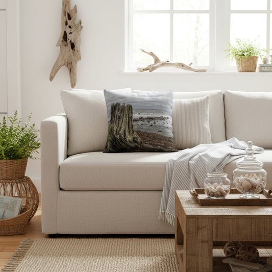 Beach theme pillow on a cream sofa.