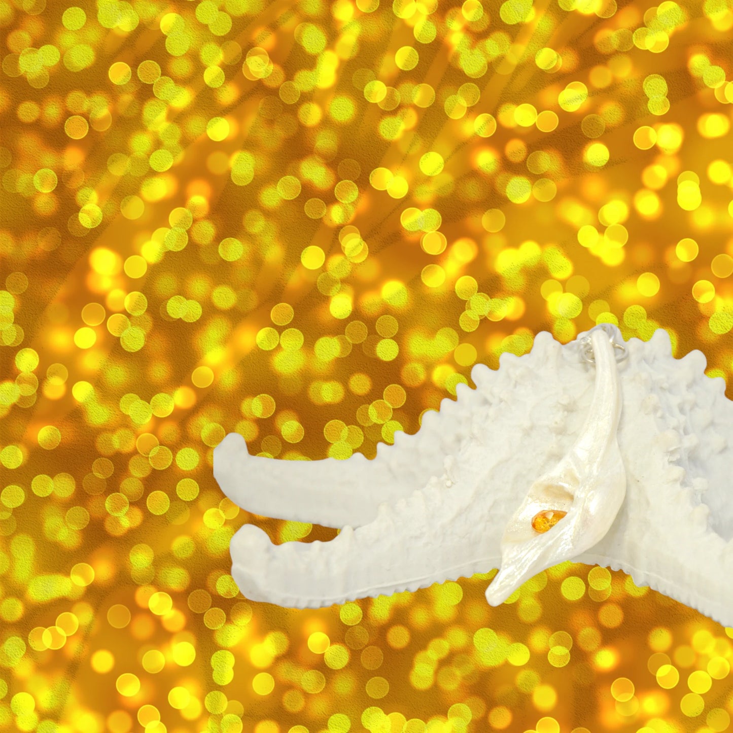 Sun Star natural seashell pendant with a beautiful pear shaped rose cut Citrine. The pendant rests on a starfish with a bright yellow bokeh background.