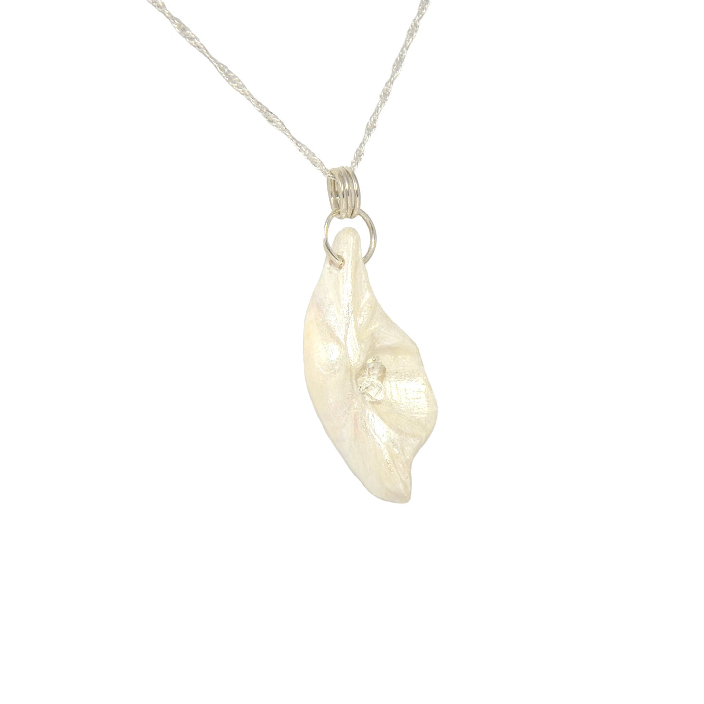 Halo natural seashell pendant with three herkimer diamonds. The pendant is shown turned so the viewer can see the right side of the pendant.