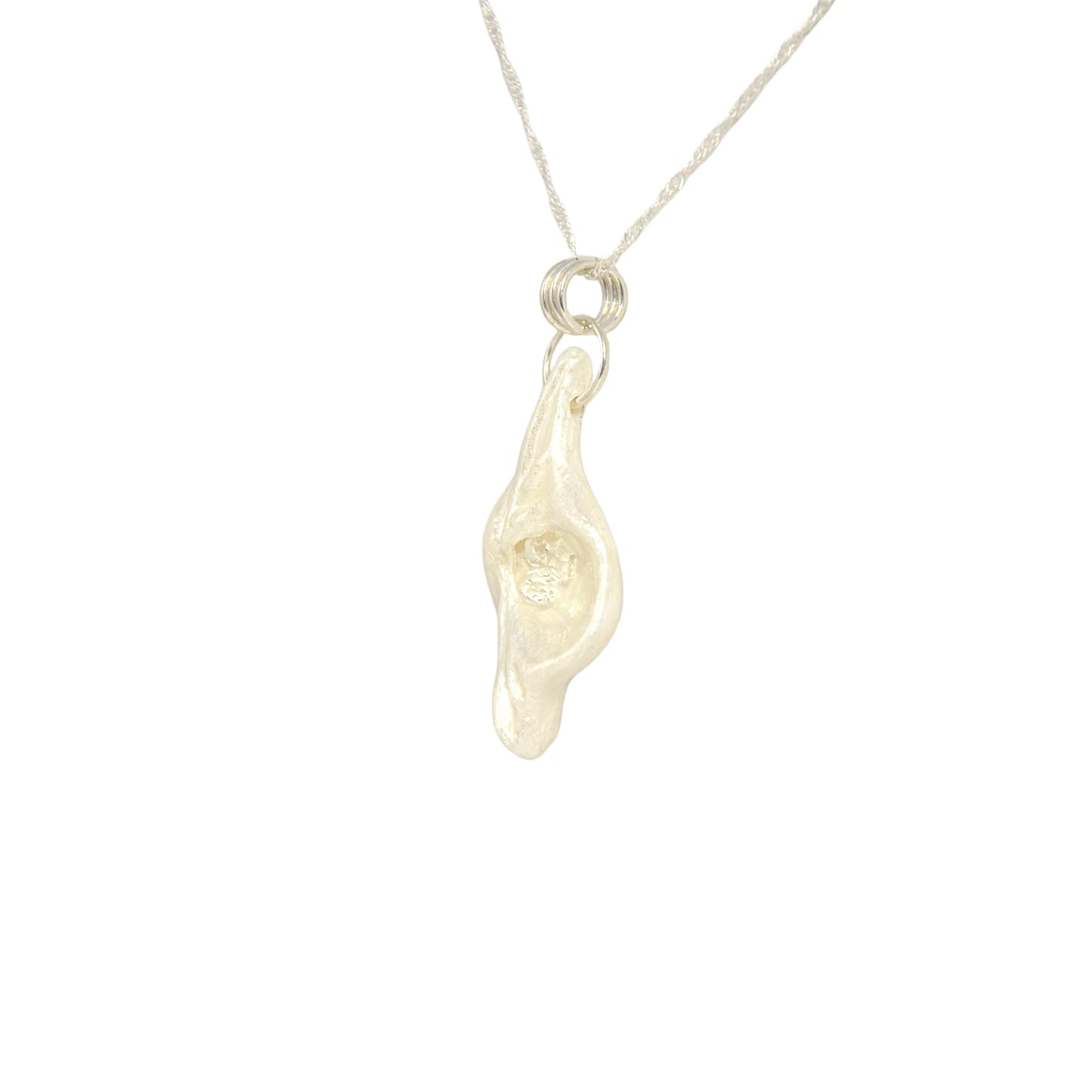 Halo natural seashell pendant with three herkimer diamonds. The pendant is turned so the viewer can see the right side of the pendant.