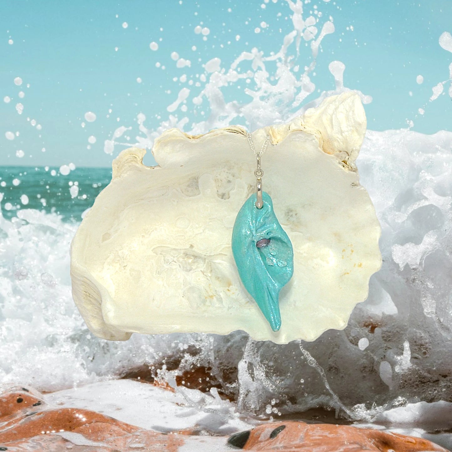 Violet Light is a natural seashell pendant with a rose cut Amethyst Gemstone and three Herkimer diamonds. The ocean waves are in the background.