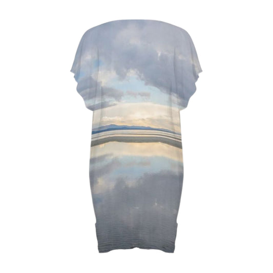 Back side All over print beach dress with a image of early morning light at the beach with sky reflecting in the ocean water.