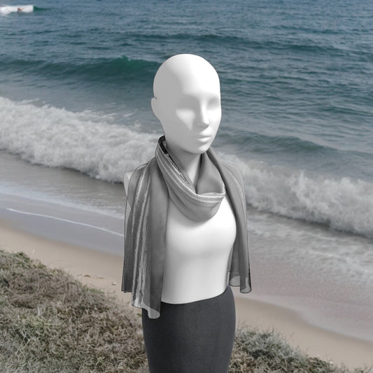 Long Beach Tofino long scarf worn around the neck on a person walking along the shoreline.