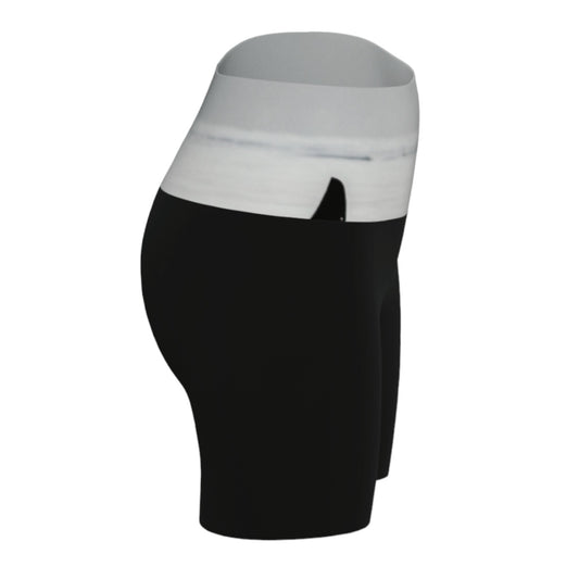 Orca spy Hop yoga shorts features an image of a orca doing the spy hop printed on the waistband. The rest of the shorts are black.