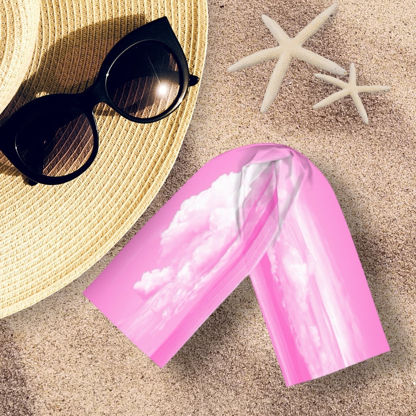 Parksville Beach long scarf is shown on the sand with a hat and sunglasses.