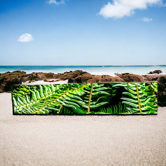 Rainforest long scarf is shown full length on a beach.