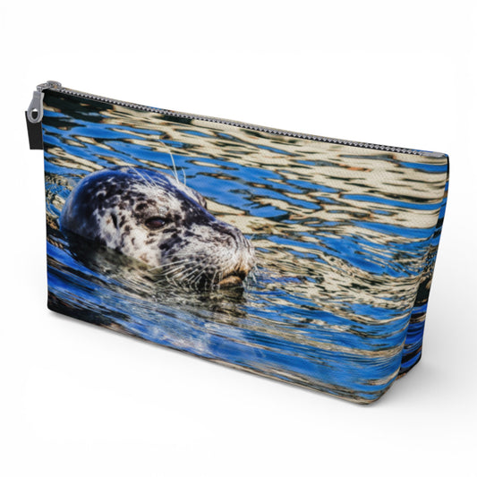 Pouch with a seal design on a blue and gray patterned background