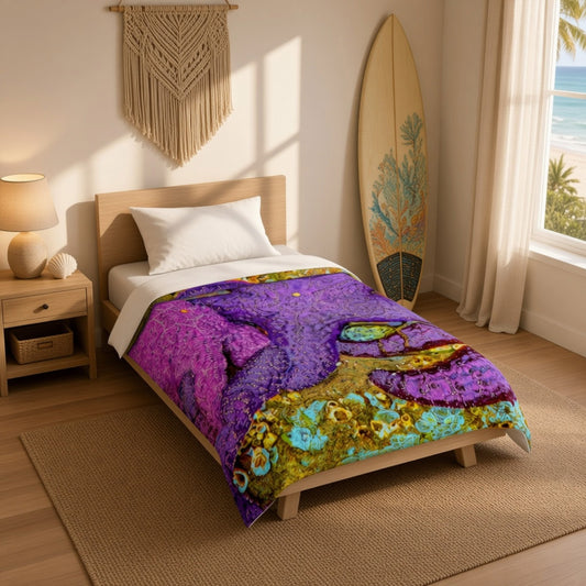 A single bed in a bright beach-themed bedroom features a colorful printed comforter with a purple starfish and tropical coral design. A wooden surfboard leans against the wall, and a window with curtains shows the ocean in the background.