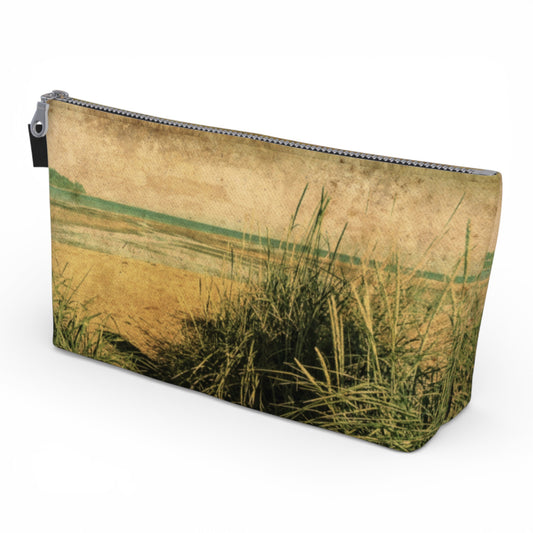 Pouch with a nature-themed design featuring grass and water on a beige background