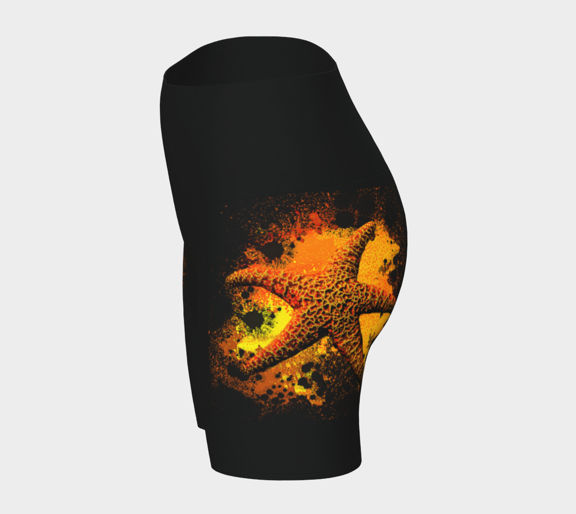 Starfish Orange Yoga Shorts features a orange starfish on a bed of abstract sand on black shorts.