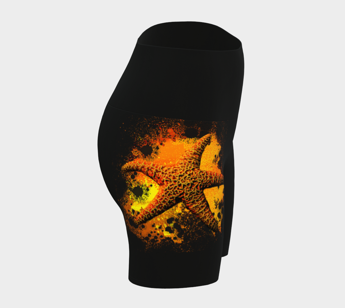 Starfish Orange Yoga Shorts features a orange starfish on a bed of abstract sand on black shorts.