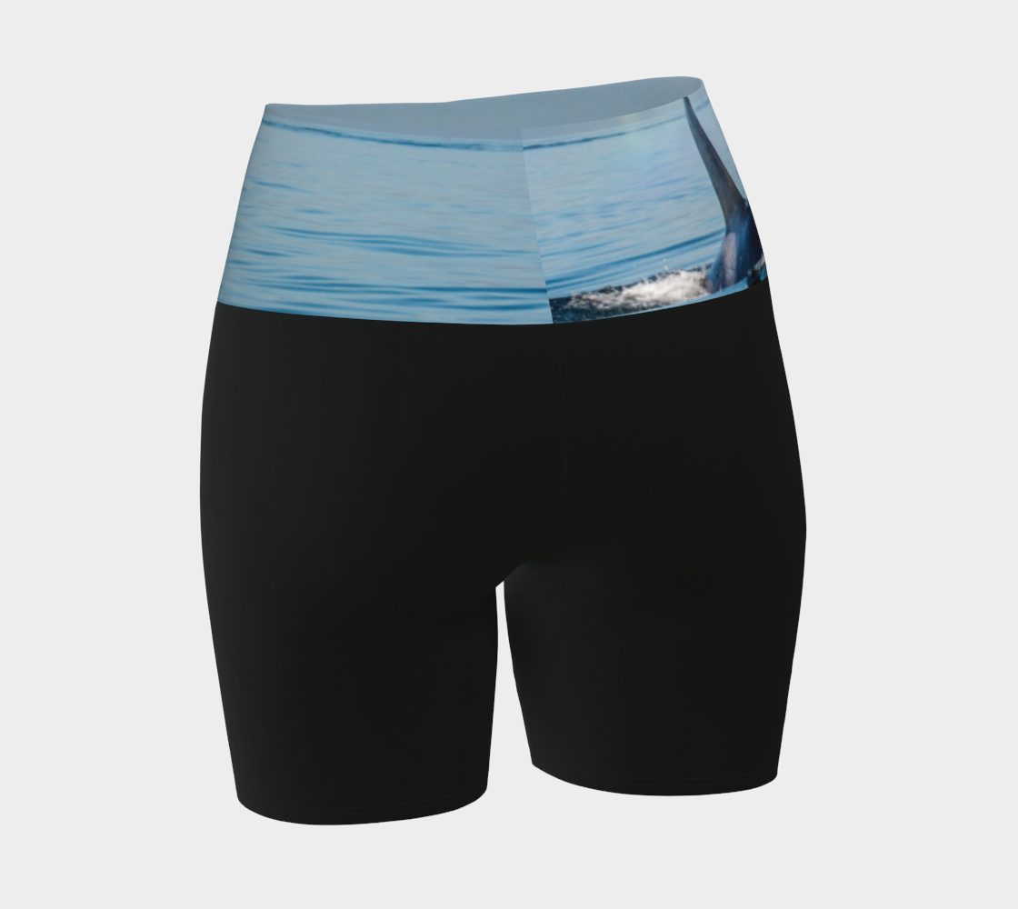 Orca Spray yoga shorts features a image of an orca exhaling on the ocean. This image is printed on the waistband and the rest of the shorts is black.