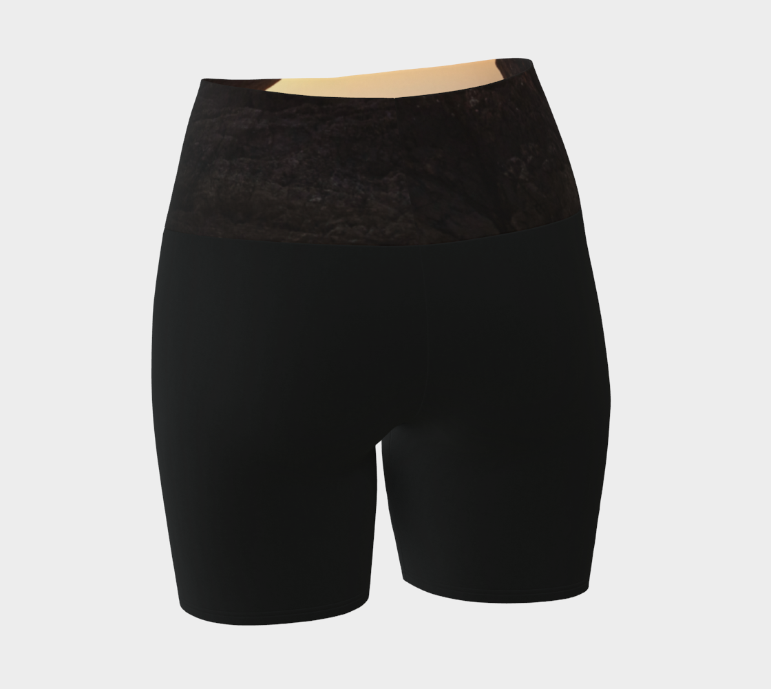 Tofino Sunset Yoga Shorts features an image of a sunset at long beach tofino printed on the waistband. the rest of the shorts are black.