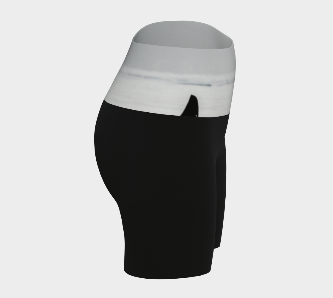 Orca spy Hop yoga shorts features an image of a orca doing the spy hop printed on the waistband. The rest of the shorts are black.