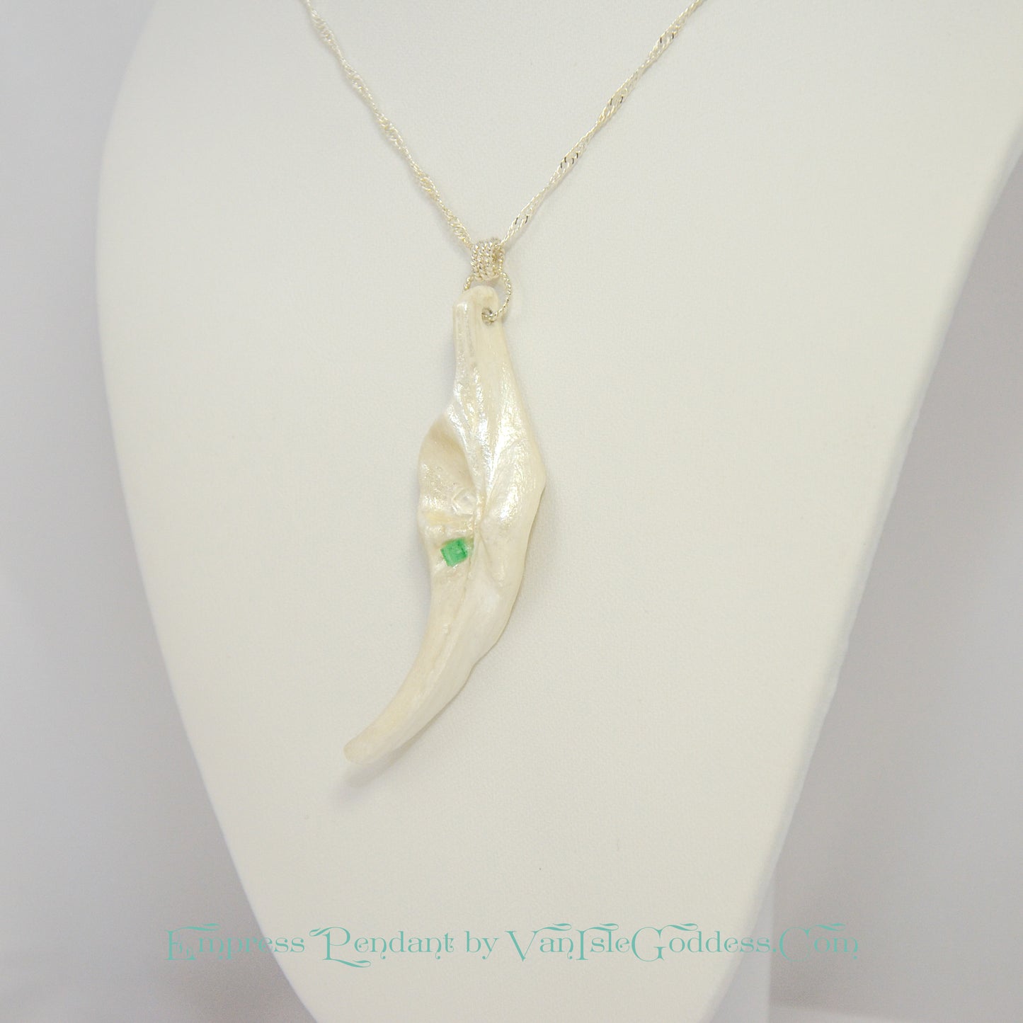 Empress natural seashell pendant with a Herkimer Diamond and Emerald. The pendant is turned to one side so the viewer can see what it looks like.