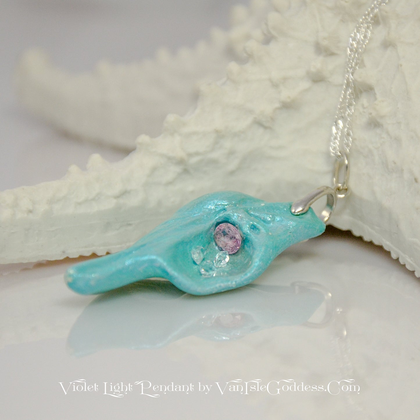 Violet Light is a natural seashell pendant with a rose cut Amethyst Gemstone and three Herkimer diamonds.