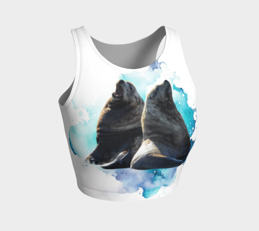 Sea Lions Communication Active Crop Top.  The image on the top is of two sea lions talking to one another. The image is on a blue turquoise abstract background on a white top.