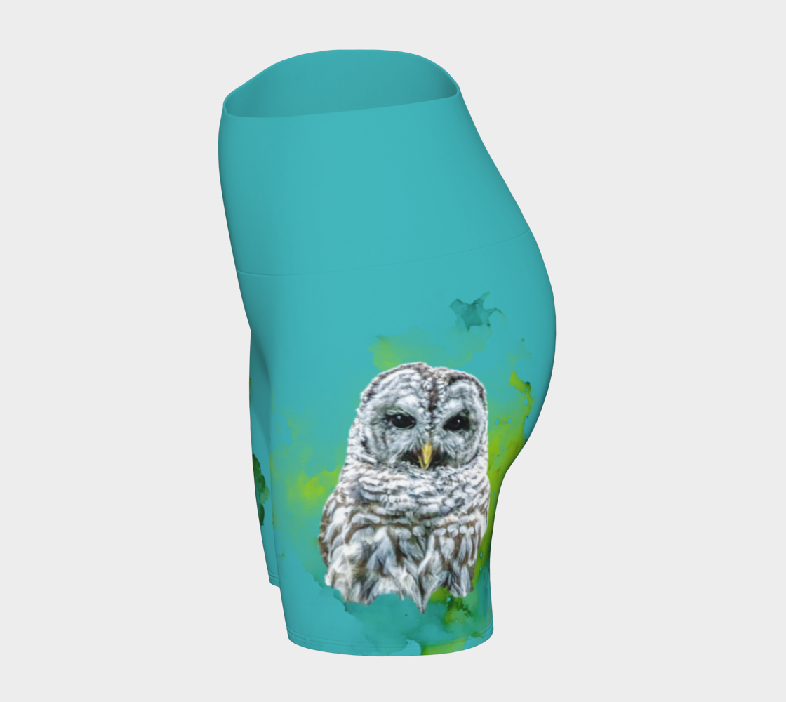 Wise owl yoga shorts features a barred owl printed on the shorts.  The rest of the shorts is turquoise in colour.
