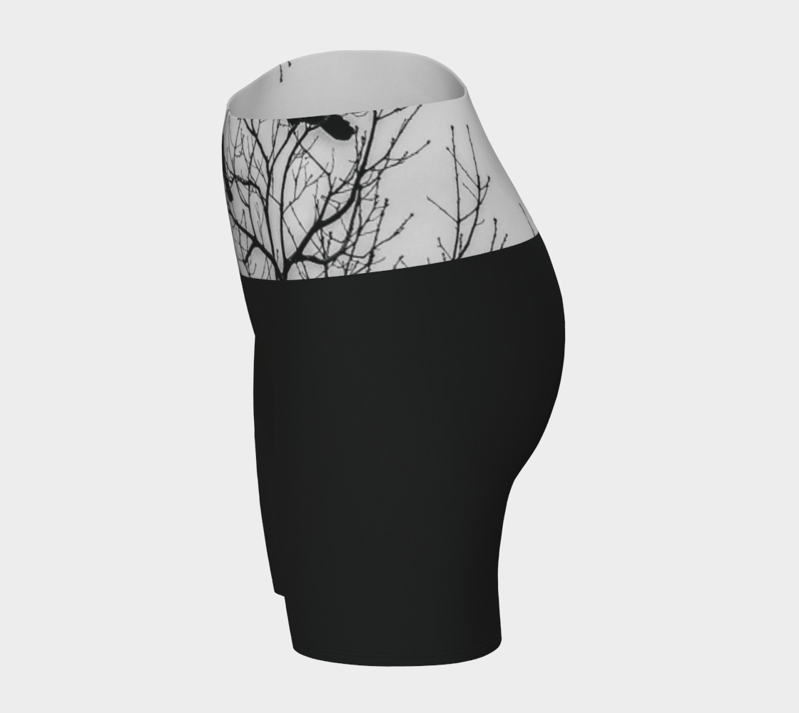 Crows Yoga Shorts feature a photograph of crows sitting in a tree printed on the band of the yoga shorts. The bottom of the yoga shorts are black.