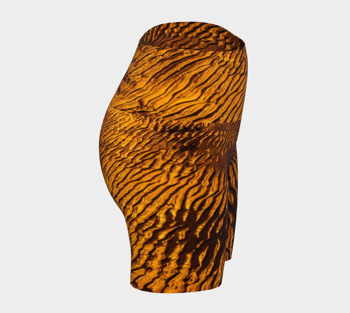 Golden Sand yoga shorts feature a image of the sand at low tide as the sun is setting it casts a golden hue across the beach. This image is printed all over the shorts.