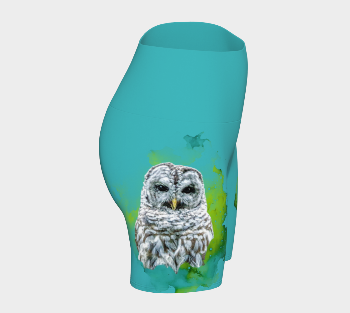 Wise owl yoga shorts features a barred owl printed on the shorts.  The rest of the shorts is turquoise in colour.