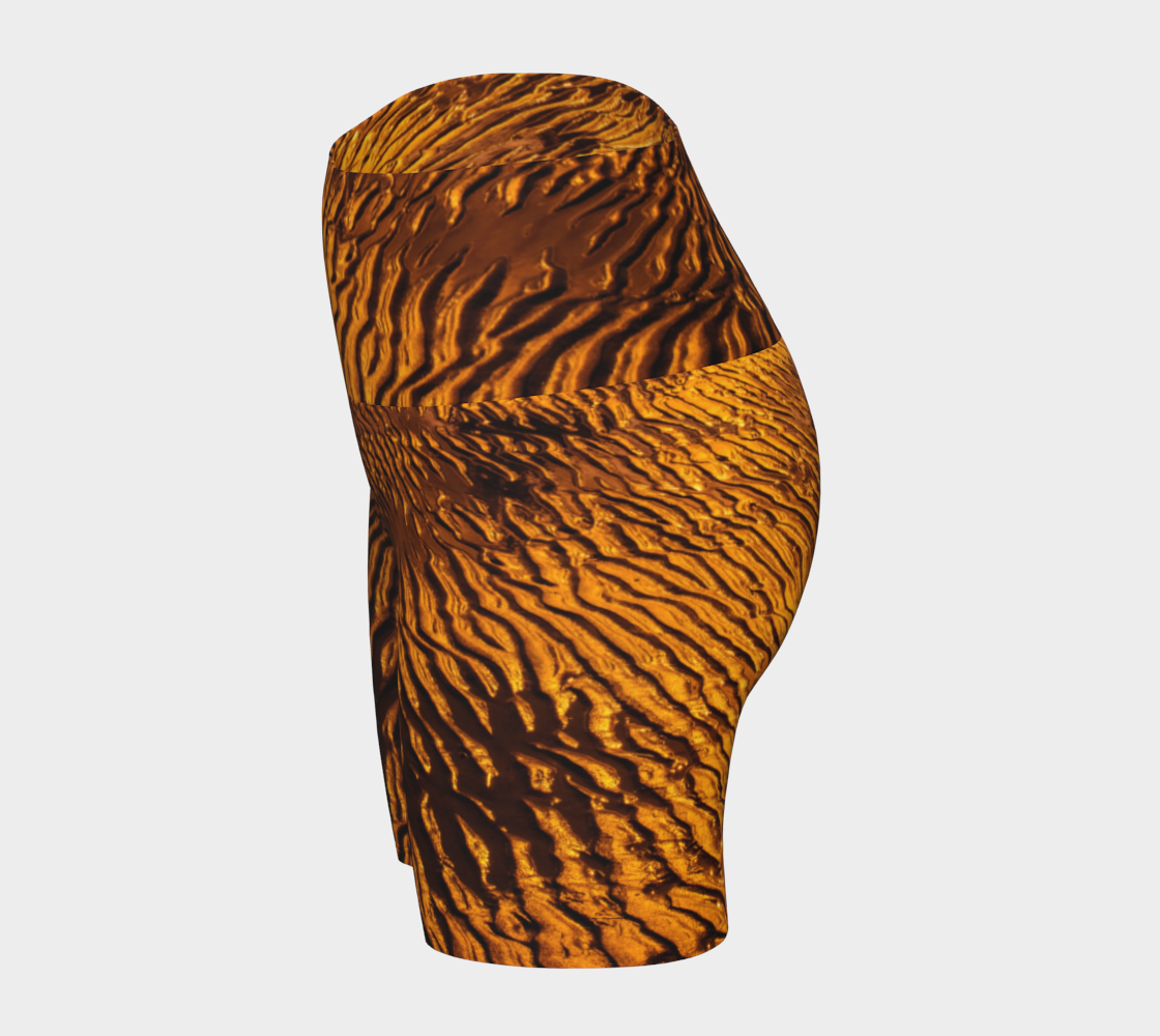 Golden Sand yoga shorts feature a image of the sand at low tide as the sun is setting it casts a golden hue across the beach. This image is printed all over the shorts.