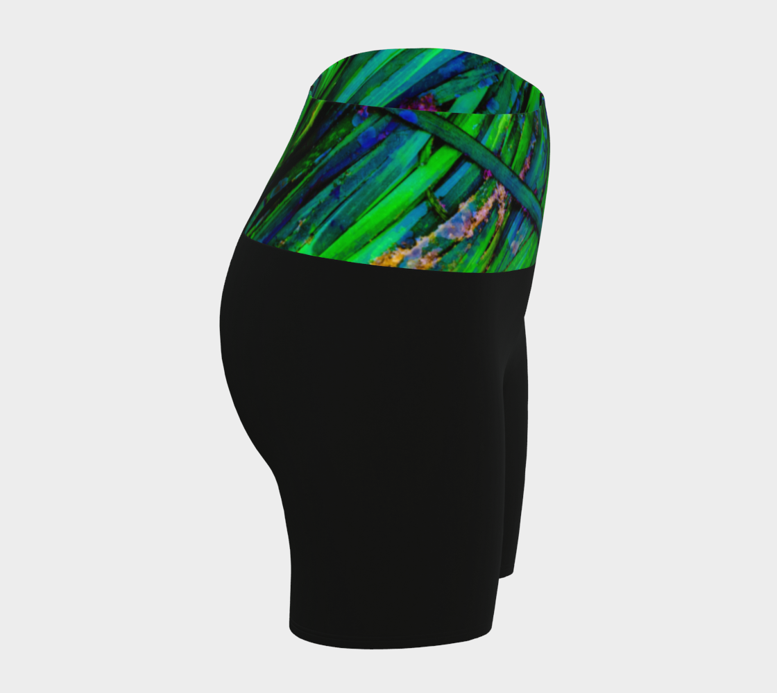 Shades of green yoga shorts features the image of spring green ocean sea grass at low tide. the rest of the shorts are black.