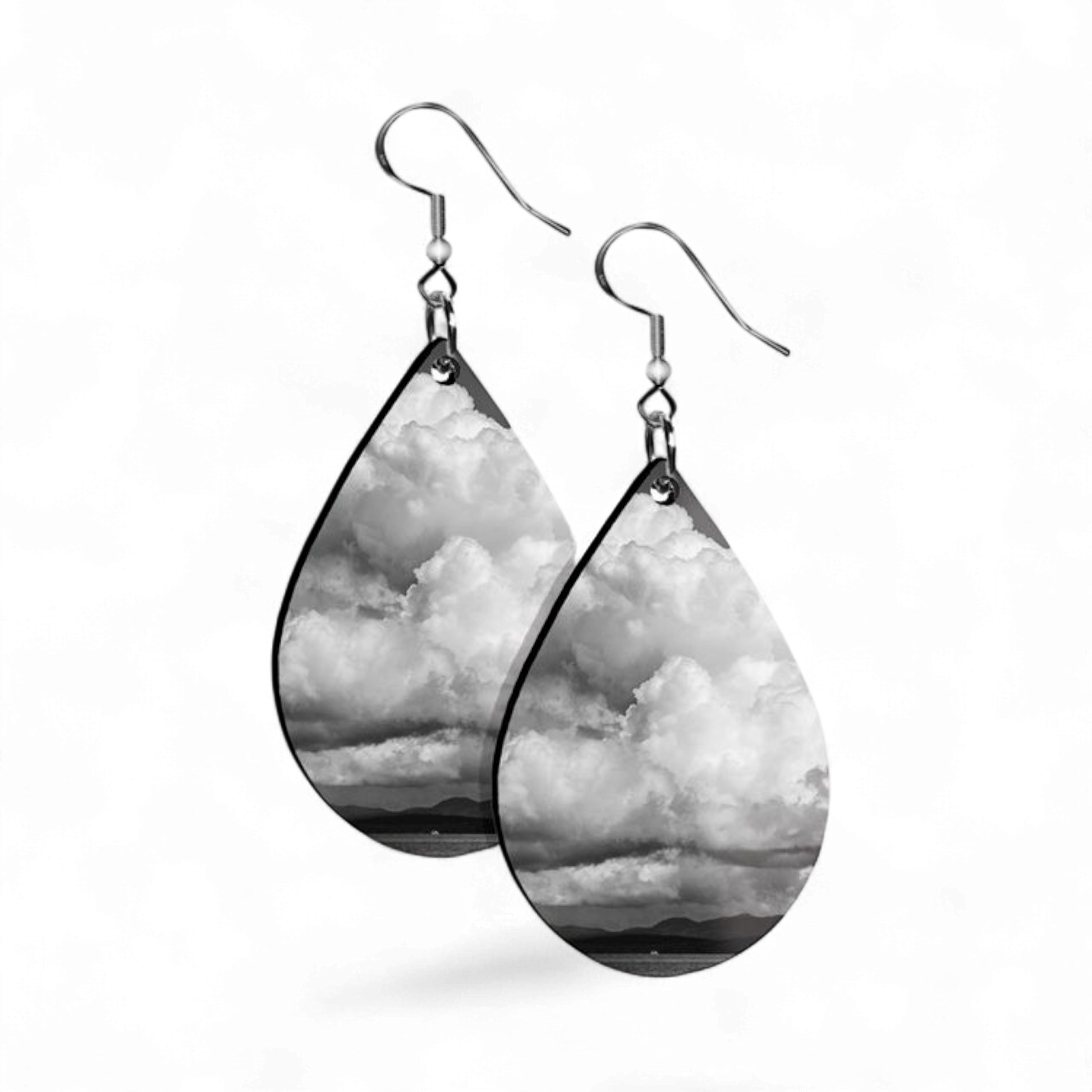 Teardrop-shaped earrings with cloud pattern on a white background