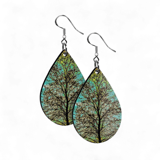 Teardrop-shaped earrings with tree design on a white background