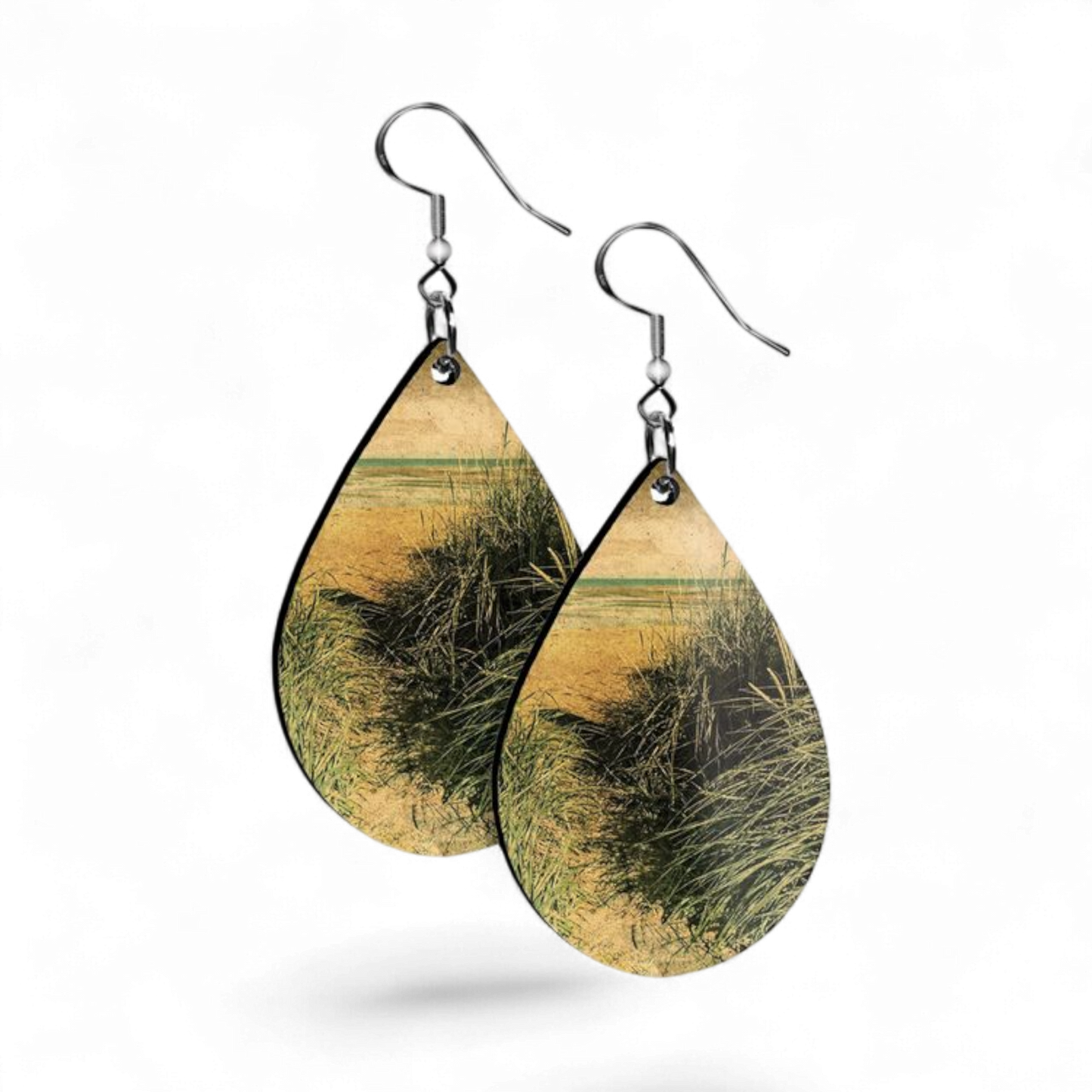 Teardrop-shaped earrings with natural design on a white background