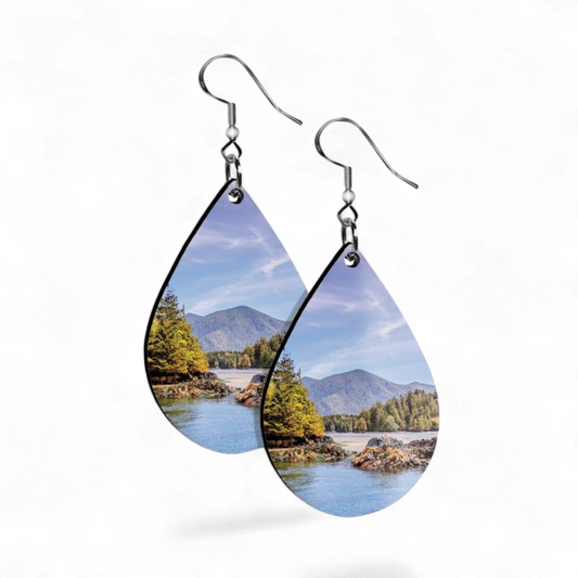 Teardrop-shaped earrings with nature scene design on a white background