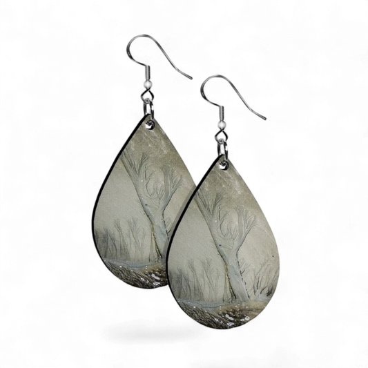 Teardrop-shaped earrings with nature-themed design on a white background