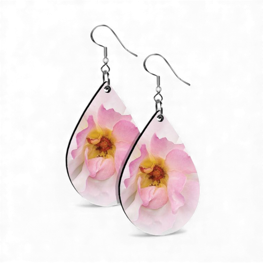 Teardrop-shaped earrings with pink floral design on a white background