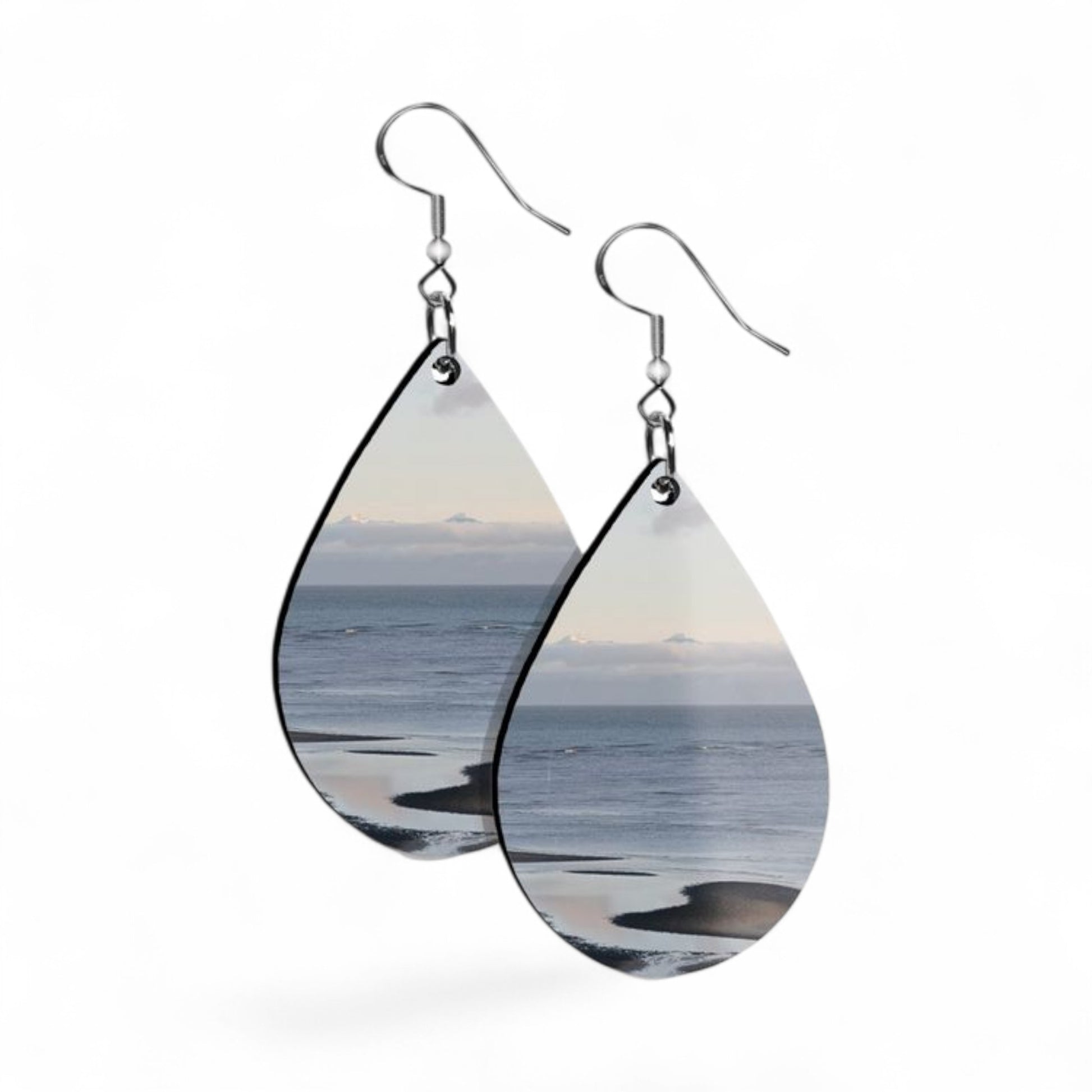 Teardrop-shaped earrings with ocean scene design on a white background