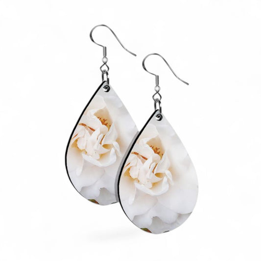 Teardrop-shaped earrings with floral design on a white background