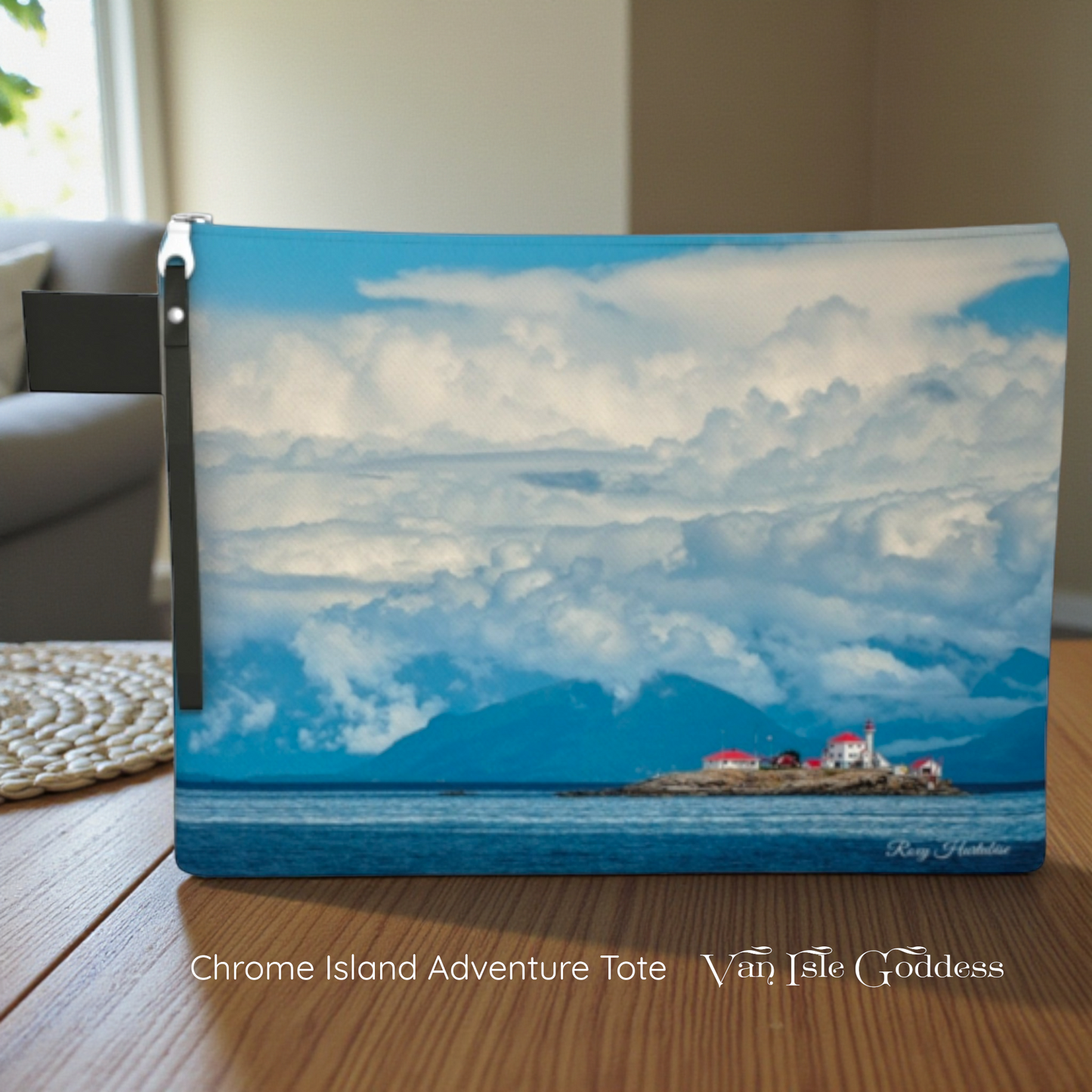 Laptop sleeve with a scenic design of a lighthouse and mountains on a wooden surface.