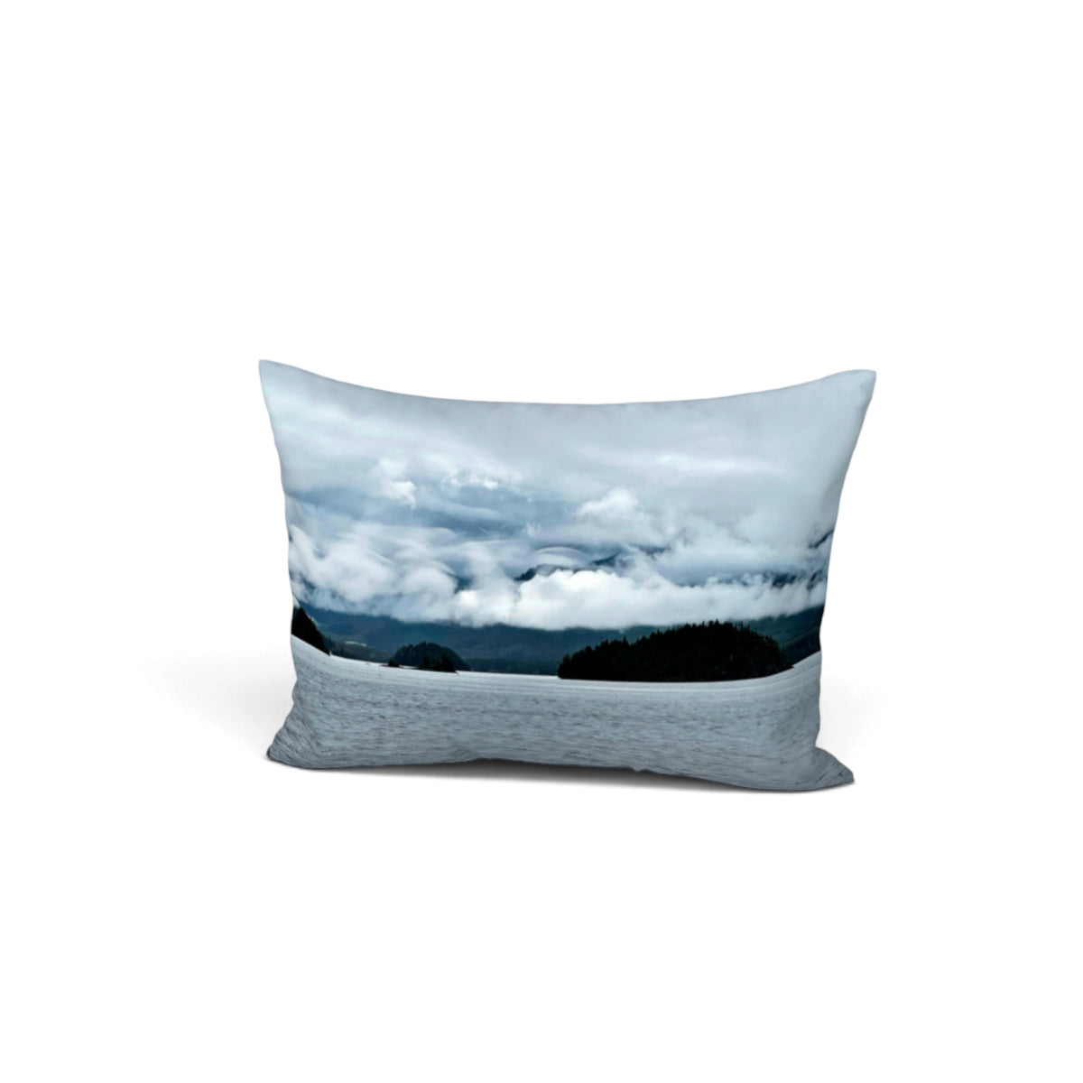 A rectangular bed pillow featuring a scenic landscape print of a cloudy sky over a lake, set against a plain white background.
