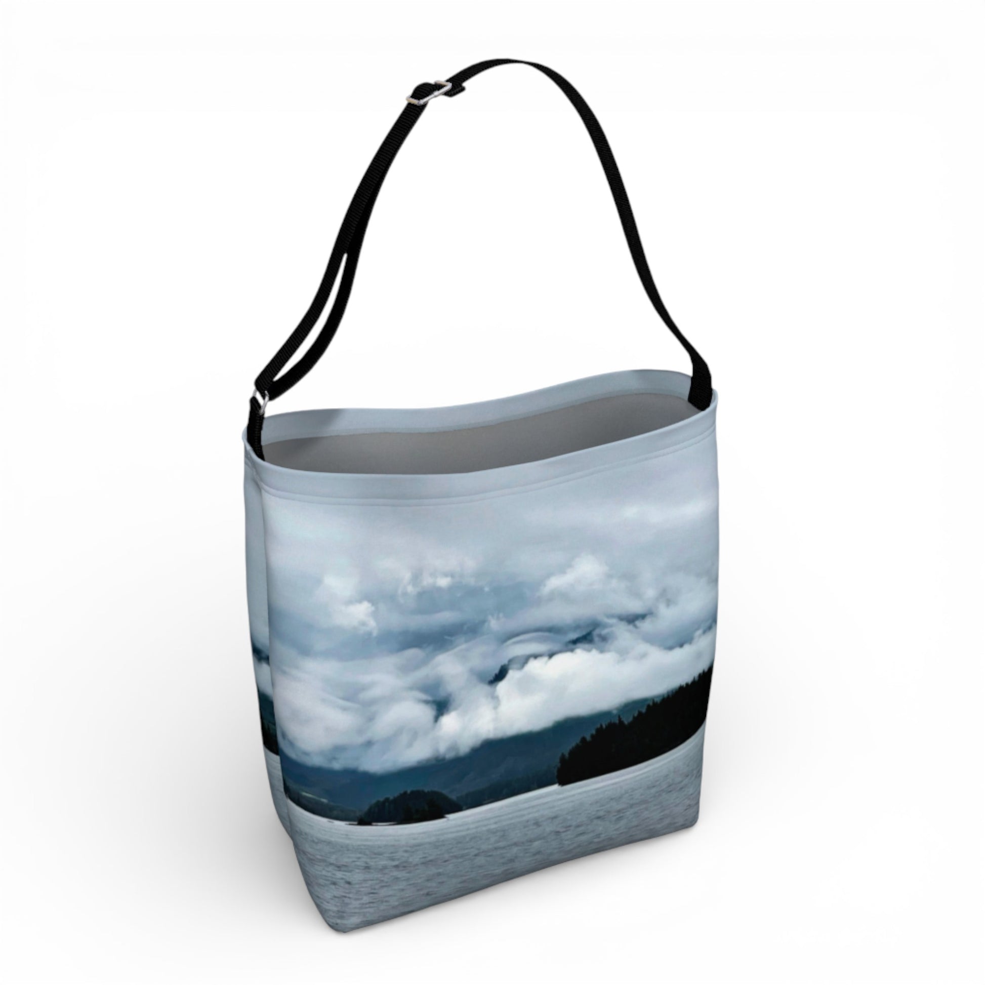Tote bag with a scenic design of mountains and clouds on a white background