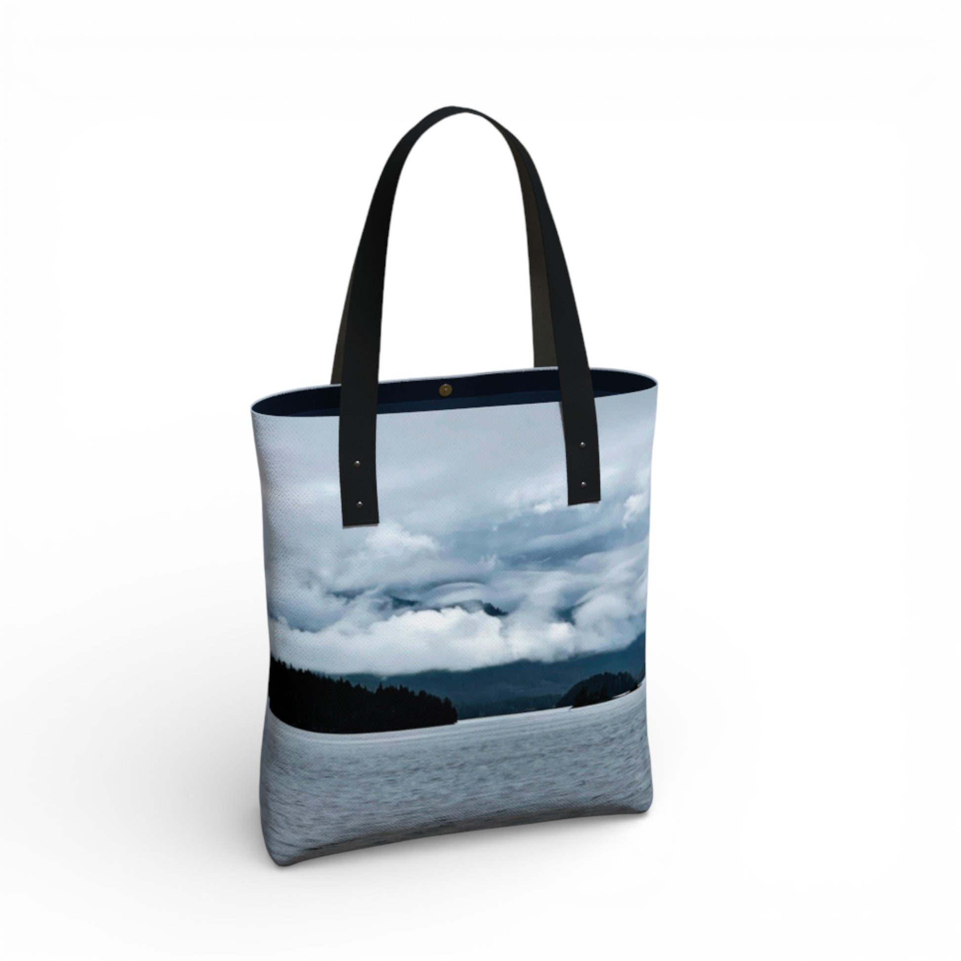 Tote bag with a scenic design of clouds and water on a white background