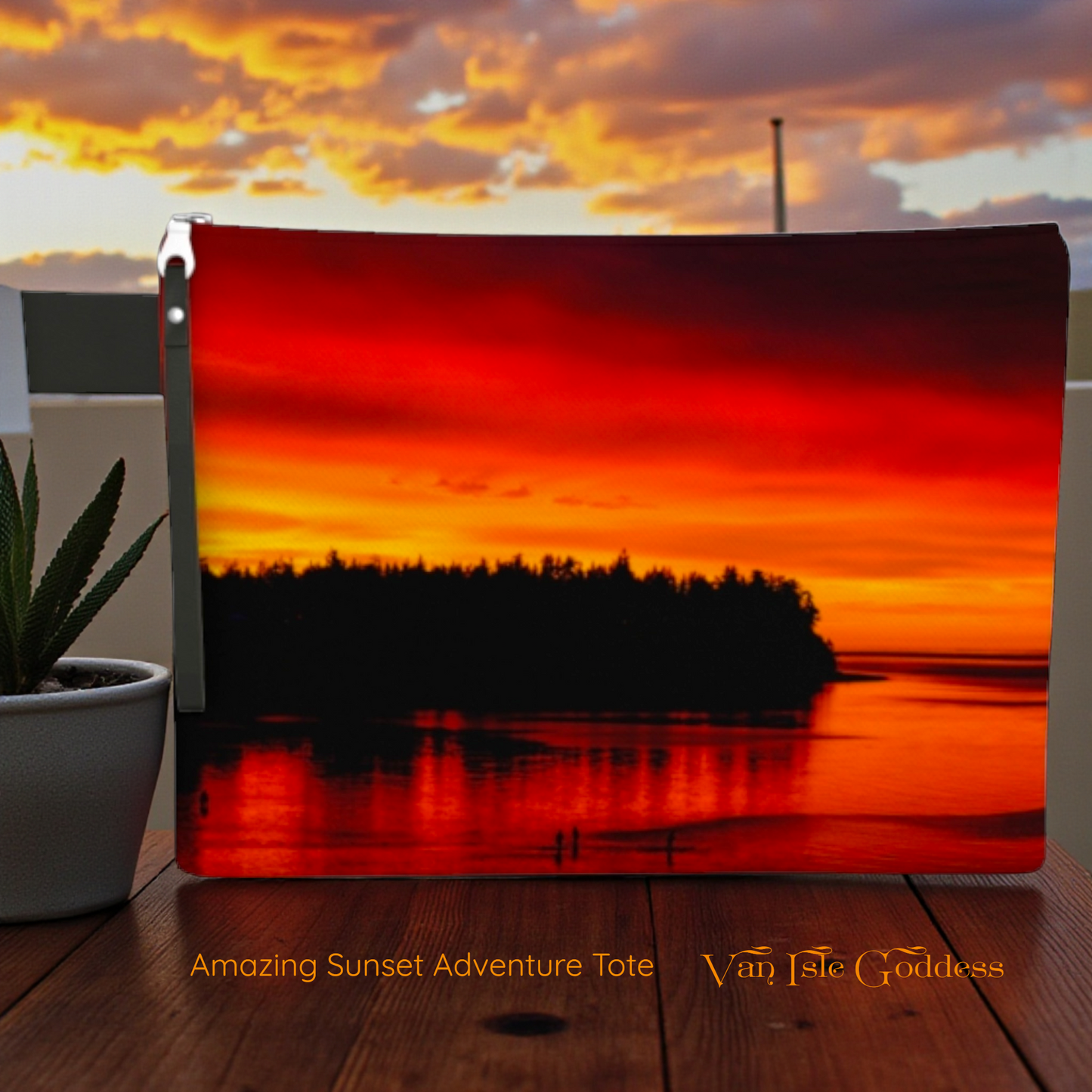 Sunset tote bag with 'Van Isle Goddess' branding on a wooden surface.
