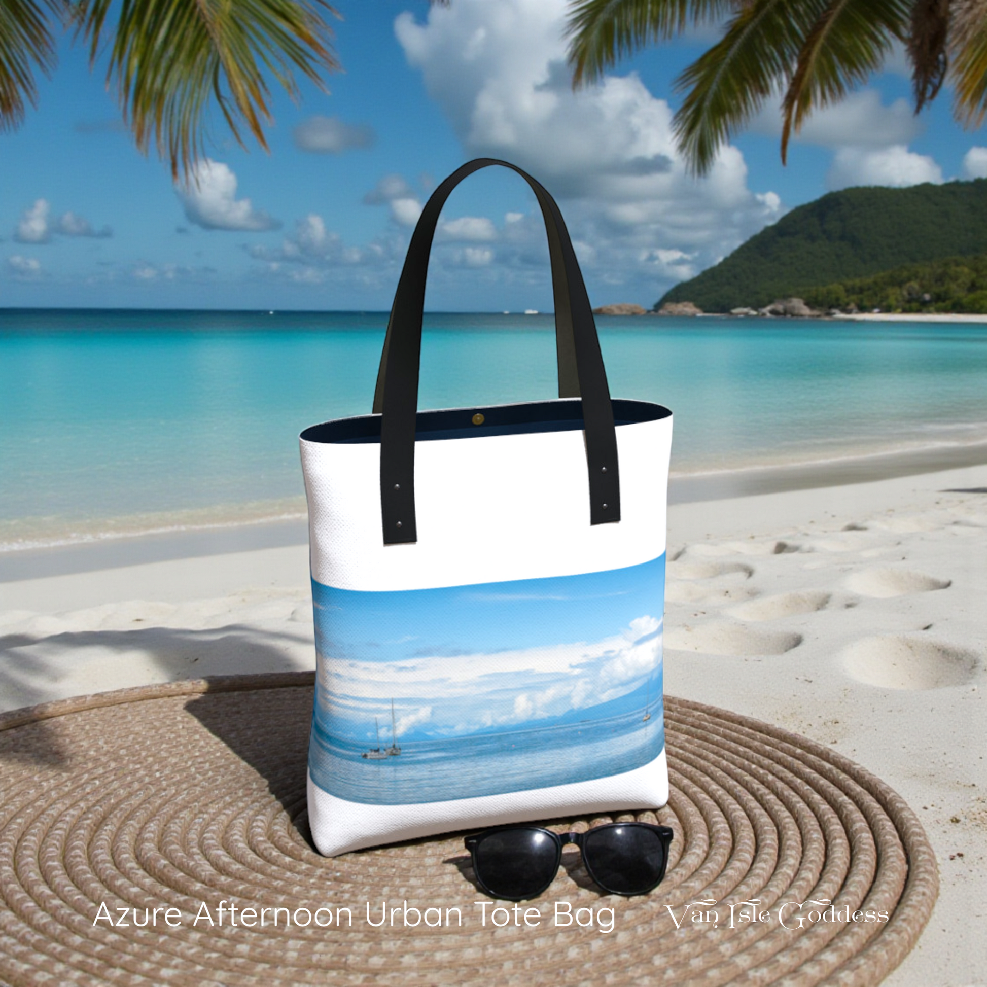 Tote bag with beach design on a sandy beach with palm trees and blue sky.